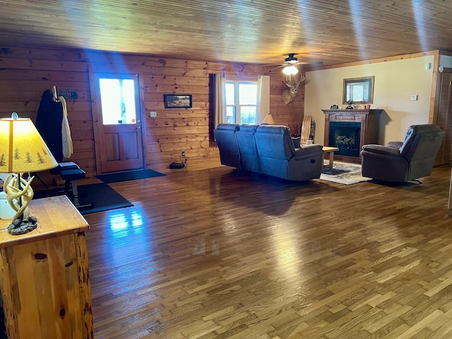 living room with wood ceiling, ceiling fan, wood-type flooring, and plenty of natural light