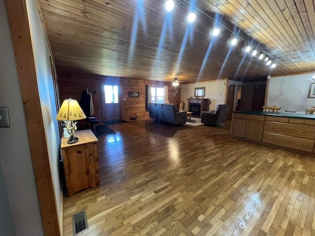 interior space with wood ceiling, ceiling fan, and hardwood / wood-style flooring