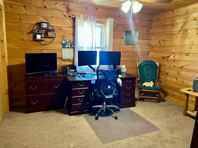 home office featuring light carpet and wood walls