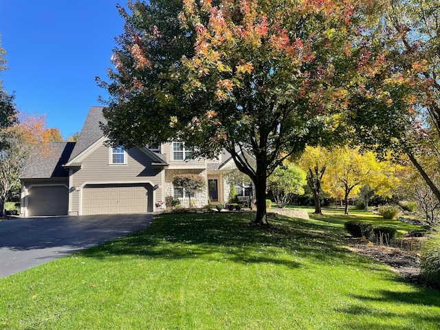 view of front facade featuring a garage and a front yard