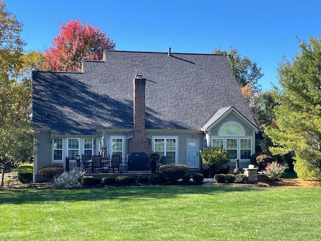 rear view of property with a yard