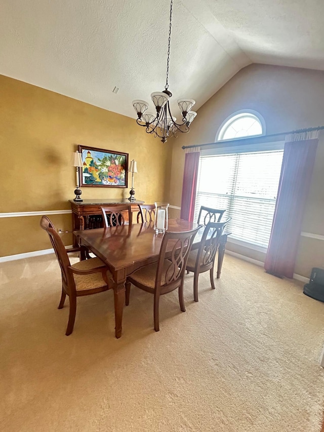 carpeted dining room featuring vaulted ceiling, a textured ceiling, and an inviting chandelier