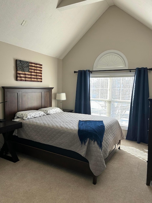 carpeted bedroom featuring vaulted ceiling and a textured ceiling