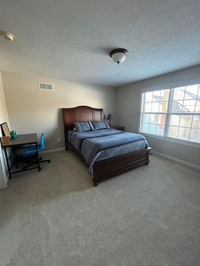 carpeted bedroom featuring a textured ceiling