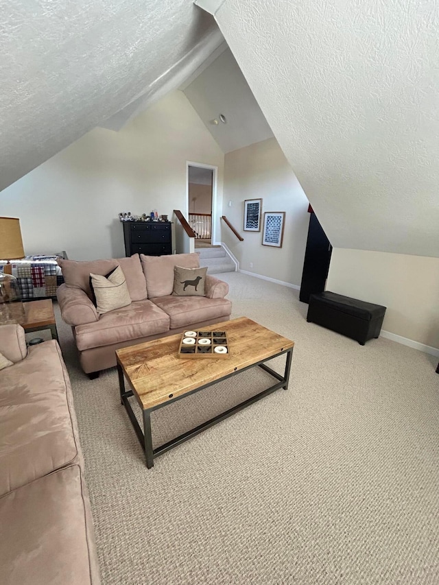 living room featuring vaulted ceiling, carpet floors, and a textured ceiling