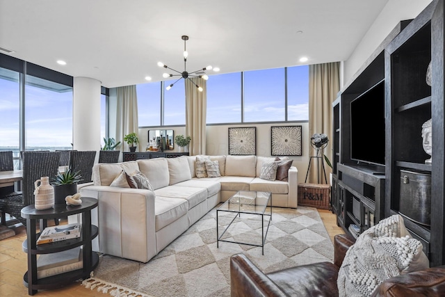 living room featuring floor to ceiling windows, a wealth of natural light, and an inviting chandelier