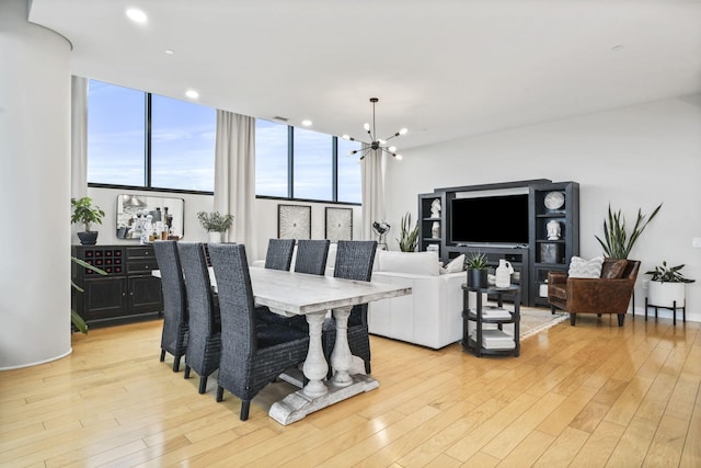 dining area featuring light hardwood / wood-style floors and a chandelier