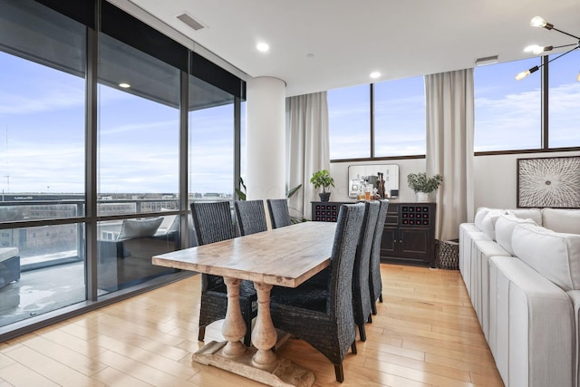 dining area featuring floor to ceiling windows and light wood-type flooring