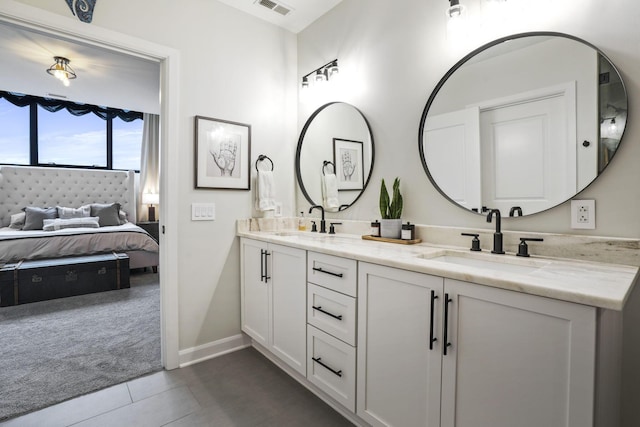 bathroom with tile patterned floors and vanity