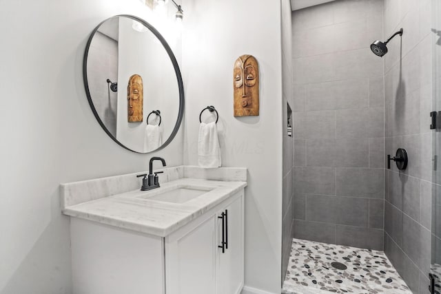 bathroom featuring vanity and tiled shower