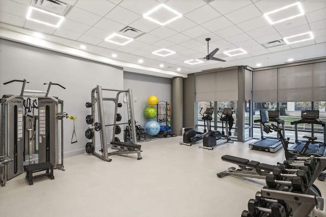 exercise room with a paneled ceiling and ceiling fan