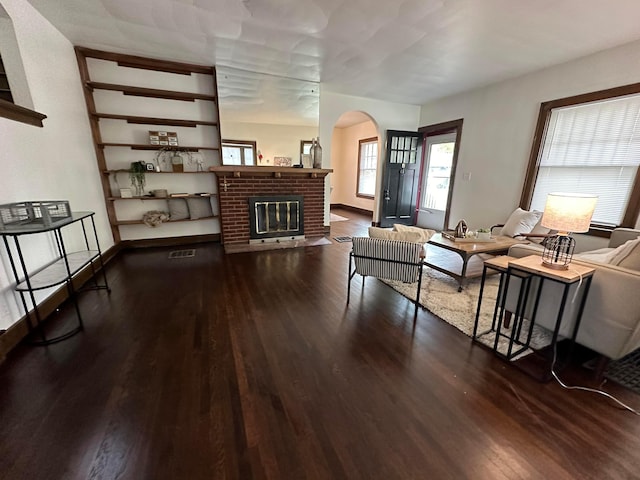 living room featuring wood-type flooring and a fireplace