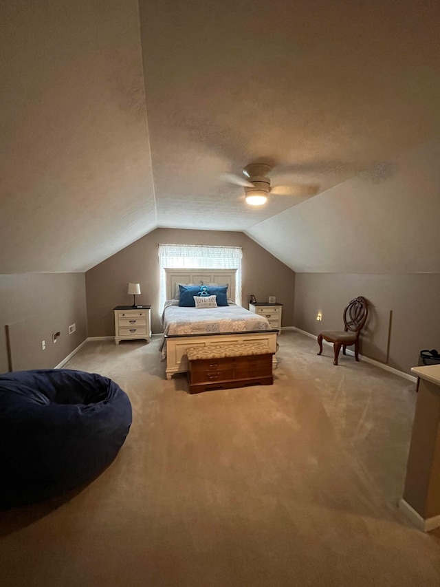 bedroom featuring lofted ceiling, light colored carpet, a textured ceiling, and ceiling fan