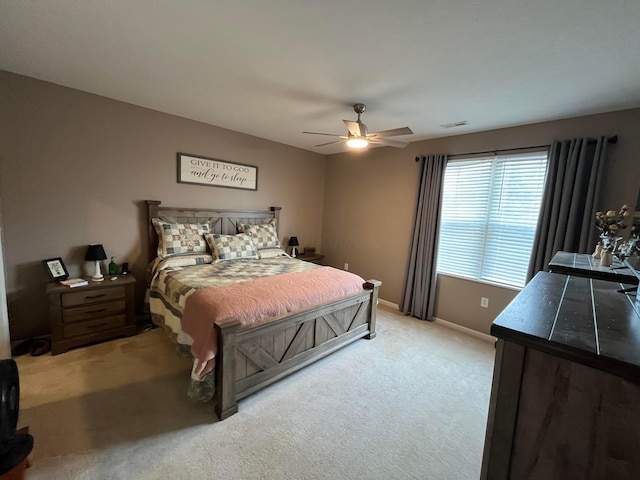 bedroom featuring ceiling fan and light carpet