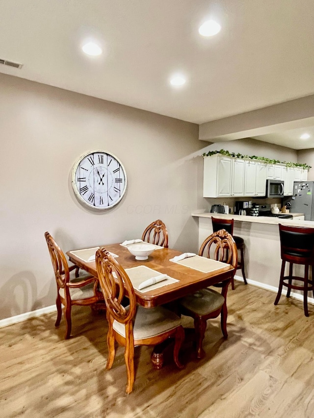 dining room with light hardwood / wood-style flooring