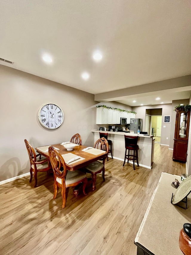 dining space featuring light hardwood / wood-style floors