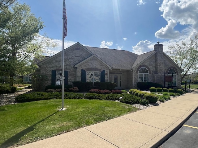 1240 Paddock Loop, Washington Court House, OH 43160 - french country home with stone siding, a front lawn, and a chimney