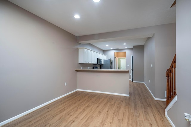 1240 Paddock Loop, Washington Court House, OH 43160 - kitchen with appliances with stainless steel finishes, light wood-style floors, baseboards, a peninsula, and recessed lighting
