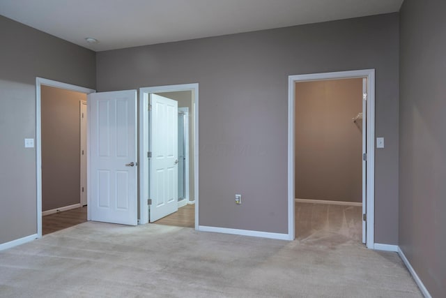 1240 Paddock Loop, Washington Court House, OH 43160 - unfurnished bedroom featuring a spacious closet, light colored carpet, baseboards, and a closet