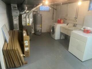 basement featuring washing machine and dryer and gas water heater