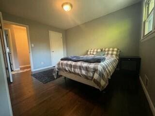 bedroom with dark hardwood / wood-style flooring