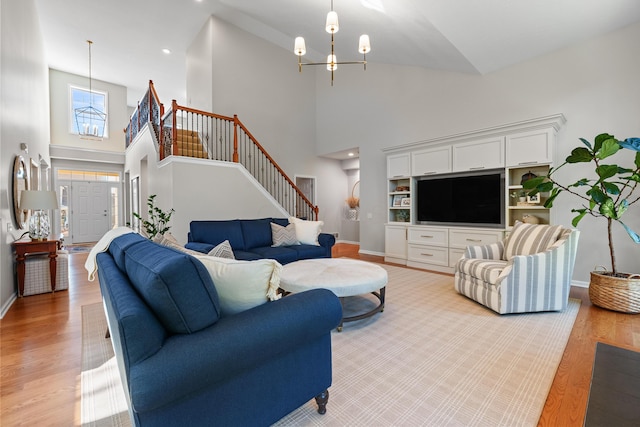 living room featuring an inviting chandelier and light hardwood / wood-style floors