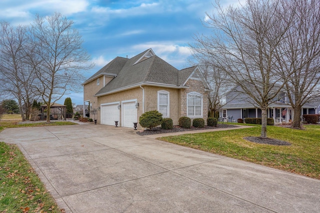 view of front of property with a garage, a gazebo, and a front yard