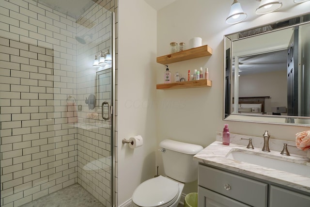 bathroom with vanity, toilet, and a shower with door