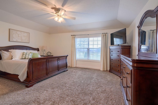 bedroom with lofted ceiling, light carpet, and a tray ceiling