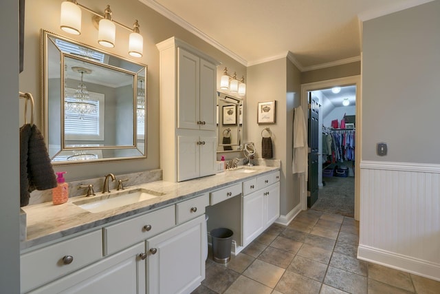 bathroom featuring crown molding and vanity