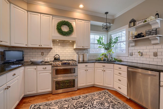 kitchen featuring pendant lighting, stainless steel appliances, light hardwood / wood-style floors, and white cabinets