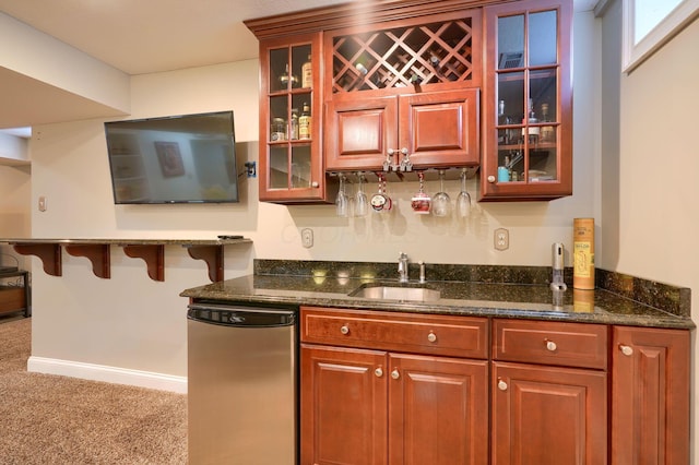 bar with dark stone countertops, sink, carpet floors, and fridge