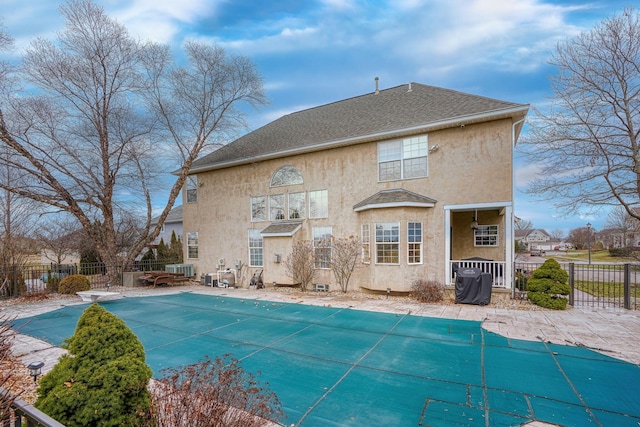 back of house with a patio area and a covered pool