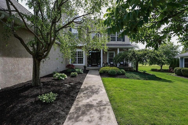 obstructed view of property featuring a front lawn and a porch