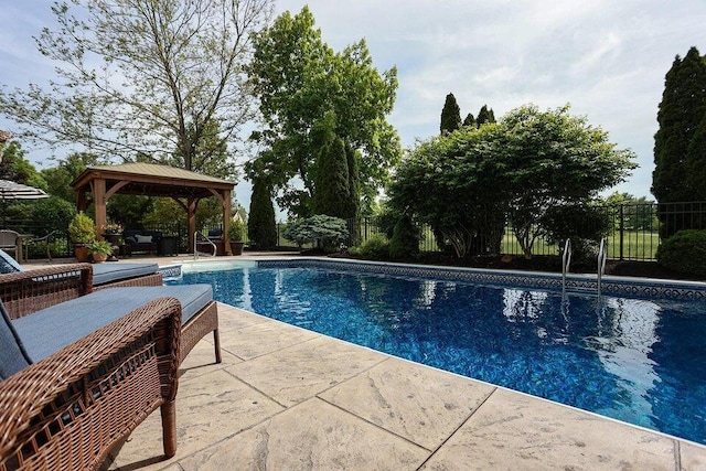 view of swimming pool with a gazebo and a patio area