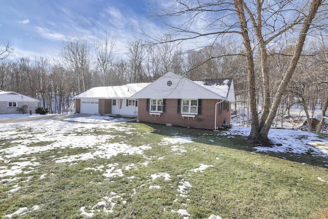 view of front of home with a garage and a yard