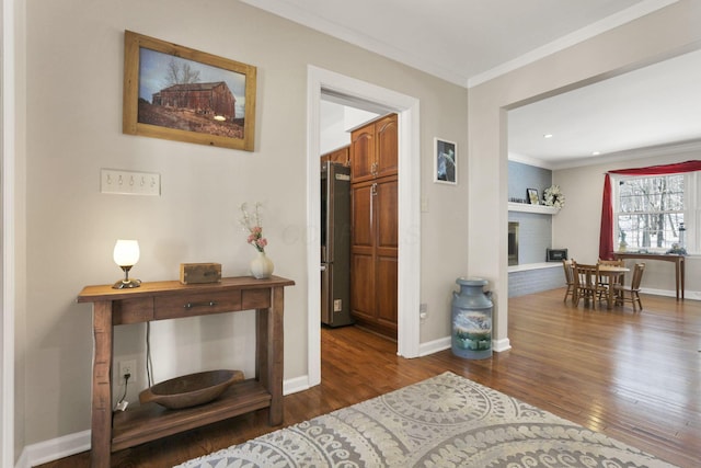 corridor with ornamental molding and dark hardwood / wood-style flooring