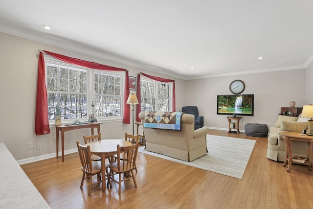 dining space featuring ornamental molding and light wood-type flooring