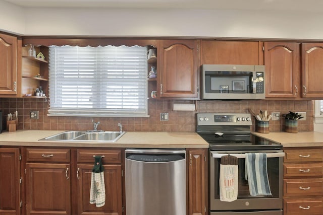 kitchen featuring stainless steel appliances, sink, and backsplash