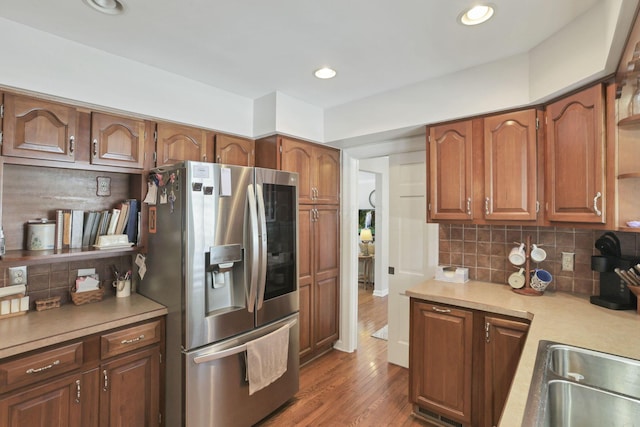 kitchen featuring tasteful backsplash, dark wood-type flooring, and stainless steel fridge with ice dispenser