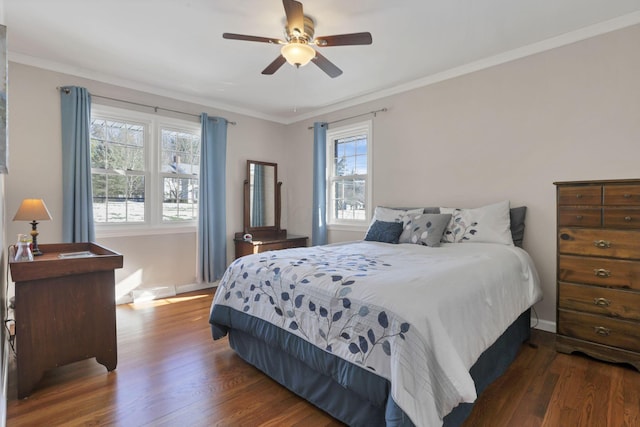 bedroom featuring dark wood-type flooring, ceiling fan, and crown molding