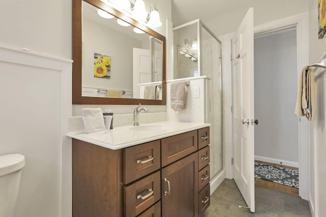 bathroom featuring walk in shower, vanity, and toilet