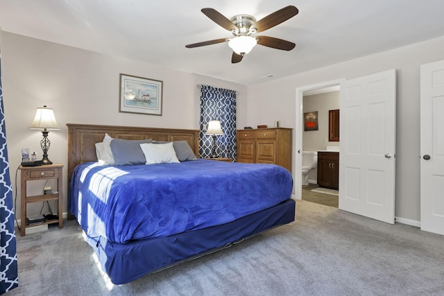 carpeted bedroom with ceiling fan and ensuite bath