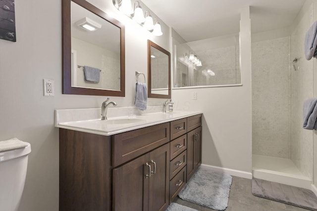 bathroom with vanity and tiled shower