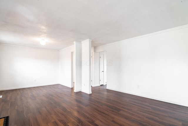 spare room featuring crown molding and dark hardwood / wood-style flooring