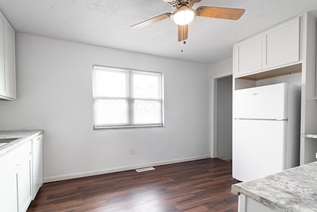 kitchen with dark wood-type flooring, white cabinetry, a textured ceiling, ceiling fan, and white appliances