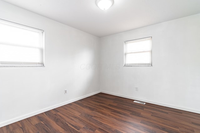 spare room featuring dark hardwood / wood-style floors