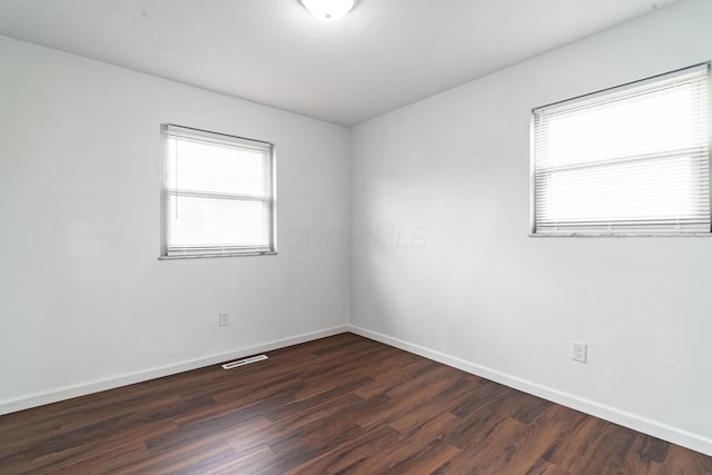 empty room featuring dark hardwood / wood-style flooring