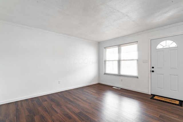 entrance foyer featuring ornamental molding, dark hardwood / wood-style floors, and a textured ceiling