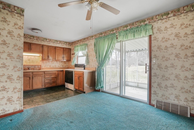 kitchen featuring ceiling fan, white electric range, and dark carpet